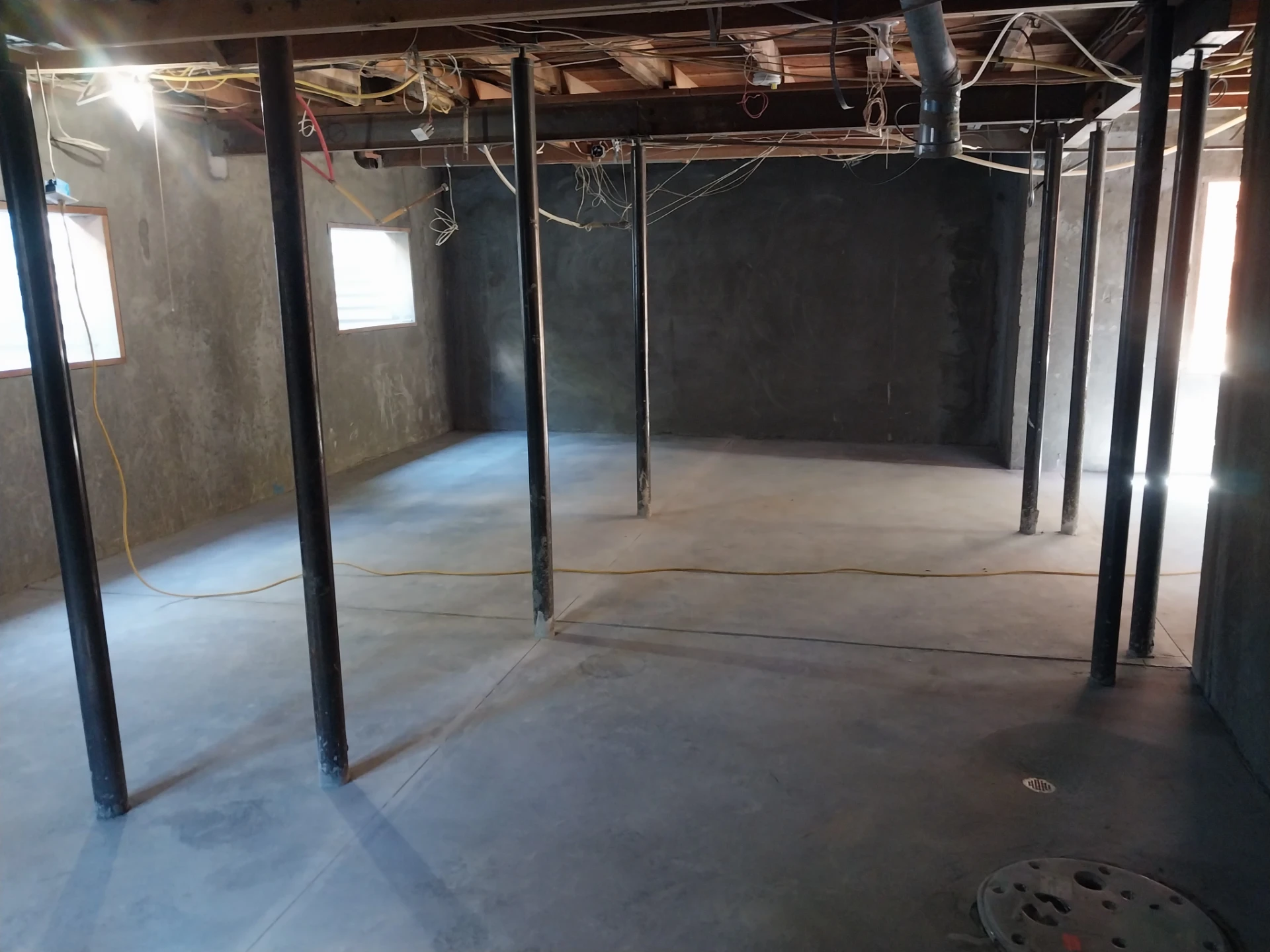 Crawl Space to Basement Conversion: Basement Framing Basement interior mid-construction with support posts, before ceiling and wiring